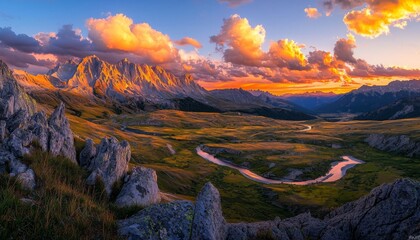 Panoramic view of a mountain landscape at sunset during golden hour, with the setting sun casting long shadows across the peaks, the sky ablaze with rich hues of orange, red, and purple, and a river