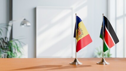 FLAGS OF ANDORRA AND SOUTH SUDAN ON TABLE