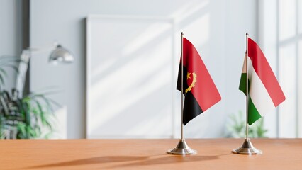 FLAGS OF ANGOLA AND HUNGARY  ON TABLE