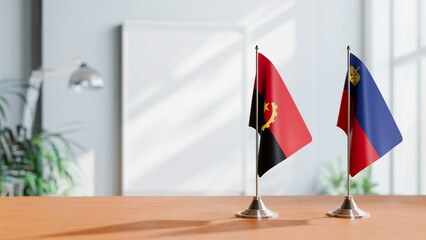 FLAGS OF ANGOLA AND LIECHTENSTEIN  ON TABLE