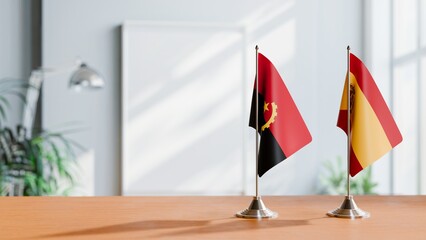 FLAGS OF ANGOLA AND SPAIN  ON TABLE