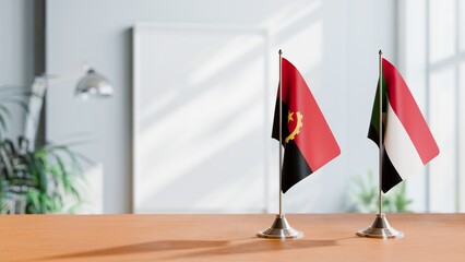 FLAGS OF ANGOLA AND SUDAN  ON TABLE