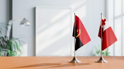 FLAGS OF ANGOLA AND TONGA  ON TABLE