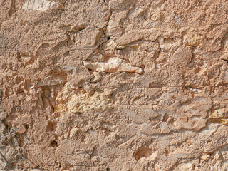 Distressed wall surface. Grunge brown and orange stone wall