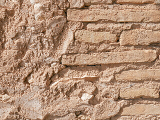Distressed wall surface. Grunge brown and orange stone wall
