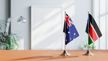FLAGS OF AUSTRALIA AND SOUTH SUDAN ON TABLE
