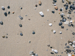 Background of colorful pebbles on the sand beach