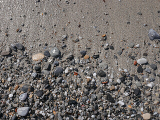 Background of colorful pebbles on the sand beach