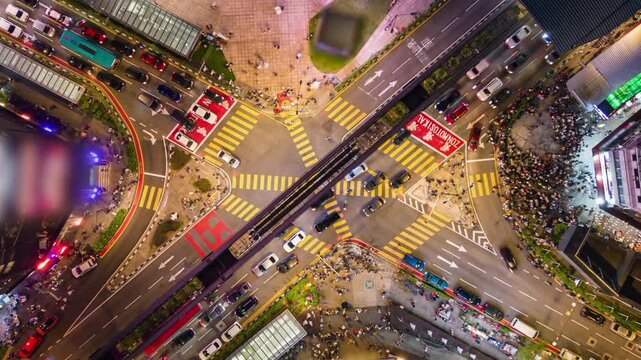 Aerial timelapse of evening traffic at Bukit Bintang intersection in downtown Kuala Lumpur, Malaysia