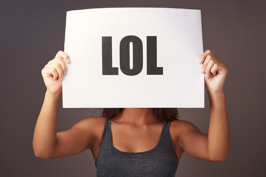 Studio, woman and poster with lol for message, reaction and laughter in conversation on social media. Female person, font text and sign in isolated background for communication, humor and expression