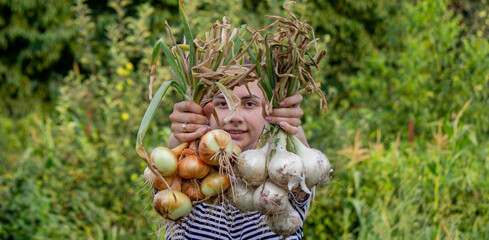 woman farmer holds onions in her hands. harvest.