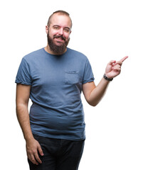 Young caucasian hipster man over isolated background with a big smile on face, pointing with hand and finger to the side looking at the camera.