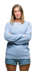 Young beautiful woman wearing winter sweater over isolated background skeptic and nervous, disapproving expression on face with crossed arms. Negative person.