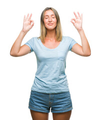 Young beautiful woman over isolated background relax and smiling with eyes closed doing meditation gesture with fingers. Yoga concept.