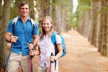 Portrait, hiking and couple with nature, woods and fitness with happiness, adventure and love. Face, forest and hike with man, woman and journey with poles, hobby and balance for wellness or travel