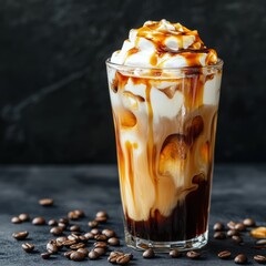 Iced coffee with cream and caramel drizzle on a dark background