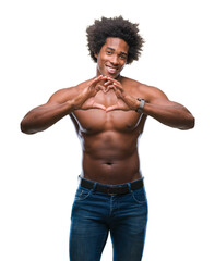 Fototapeta premium Afro american shirtless man showing nude body over isolated background smiling in love showing heart symbol and shape with hands. Romantic concept.