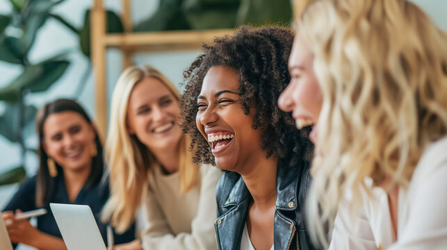 Group of Happy Women Laughing Together in a Creative Workspace