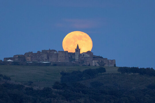 moon above medieval castle astronomy