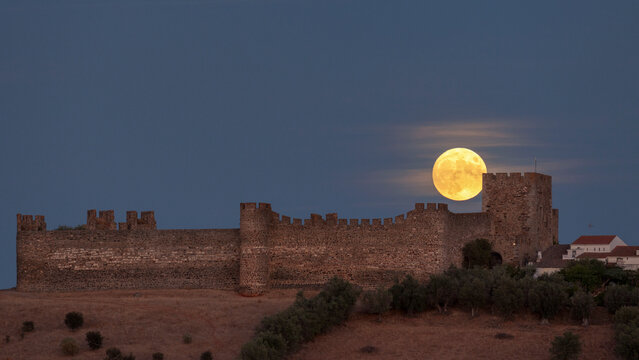 moon above medieval castle astronomy