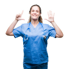 Young brunette doctor girl wearing nurse or surgeon uniform over isolated background showing and pointing up with fingers number seven while smiling confident and happy.