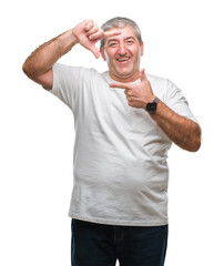 Fototapeta premium Handsome senior man over isolated background smiling making frame with hands and fingers with happy face. Creativity and photography concept.