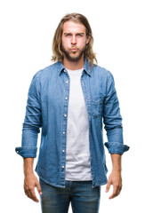 Young handsome man with long hair over isolated background puffing cheeks with funny face. Mouth inflated with air, crazy expression.