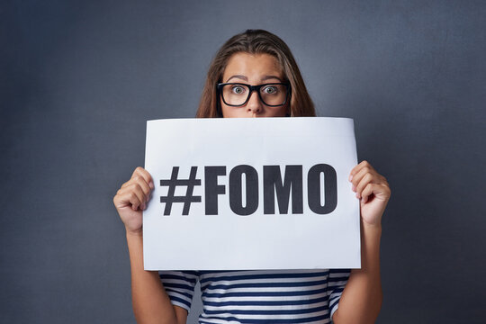 Poster, surprise and portrait of woman in studio for information, text and advertising of anxiety. Paper, embarrassed and hashtag with statement on gray background for fomo, worry or insecurity