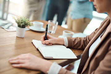 Hand, notebook and writing with business person at desk in office for memo, notes or reminder. Agenda, diary and pen with professional employee at workplace table for planning in journal closeup