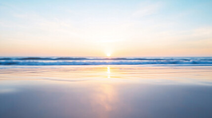 A tranquil sunrise over the ocean, with soft, pastel hues reflected on the smooth sand and calm waters, creating a peaceful and calming atmosphere.