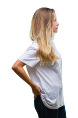 Fototapeta premium Young beautiful blonde woman wearing casual white t-shirt over isolated background looking to side, relax profile pose with natural face with confident smile.