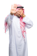 Young handsome man wearing keffiyeh over isolated background covering eyes with hands and doing stop gesture with sad and fear expression. Embarrassed and negative concept.