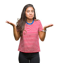 Young beautiful arab woman over isolated background clueless and confused expression with arms and...