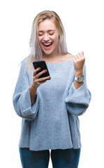 Fototapeta premium Young blonde woman texting sending message using smartphone over isolated background screaming proud and celebrating victory and success very excited, cheering emotion