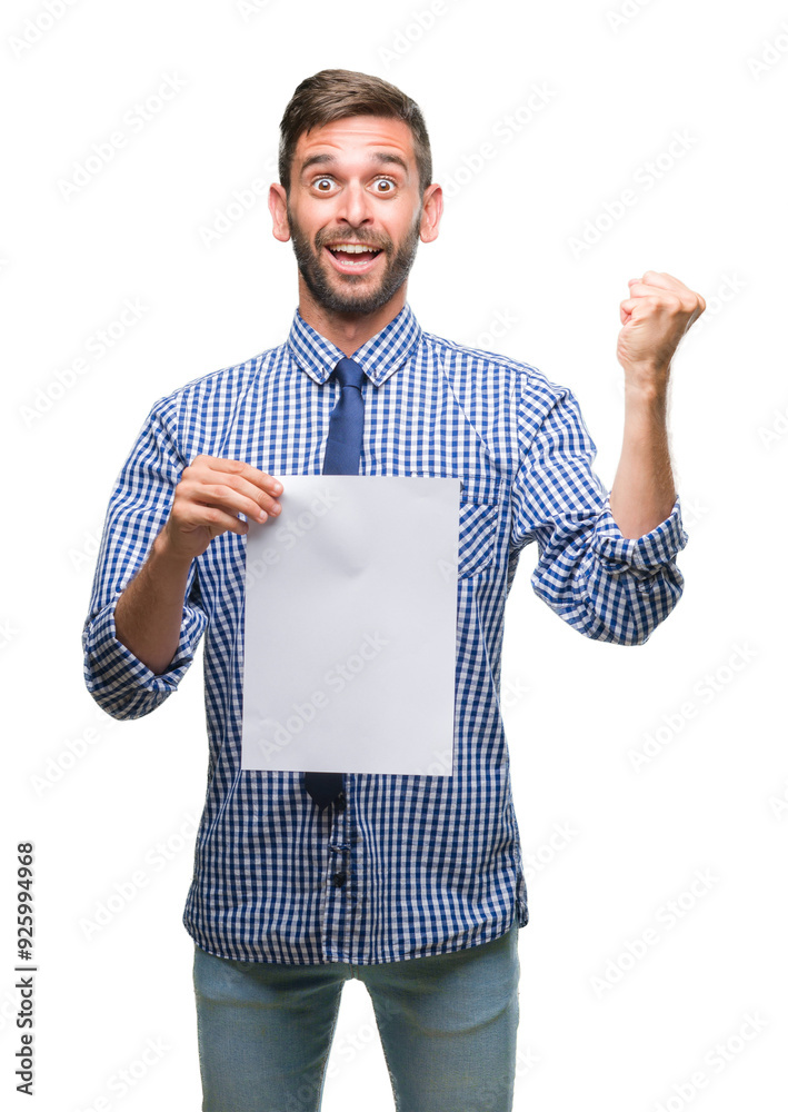 Sticker Young handsome man holding blank paper over isolated background screaming proud and celebrating victory and success very excited, cheering emotion