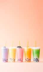 free space of variety of bobba bubble milk tea plastic cups standing in a line on pink background, Bubble Milkshake