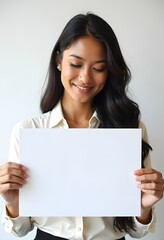 Naklejka premium Professional Woman Holding Blank Sign in Business Attire for Customizable Corporate Message or Branding