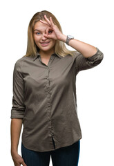 Fototapeta premium Young caucasian business woman over isolated background doing ok gesture with hand smiling, eye looking through fingers with happy face.