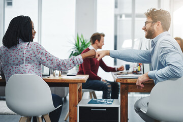 Obraz premium Man, woman and fist bump for small business, success and creative startup with online web design. Designers, diversity and digital website for internet service, project management and ux proposal