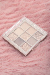 Mockup of makeup palette eye shadow on pink background. Cosmetics products mock-up for branding.