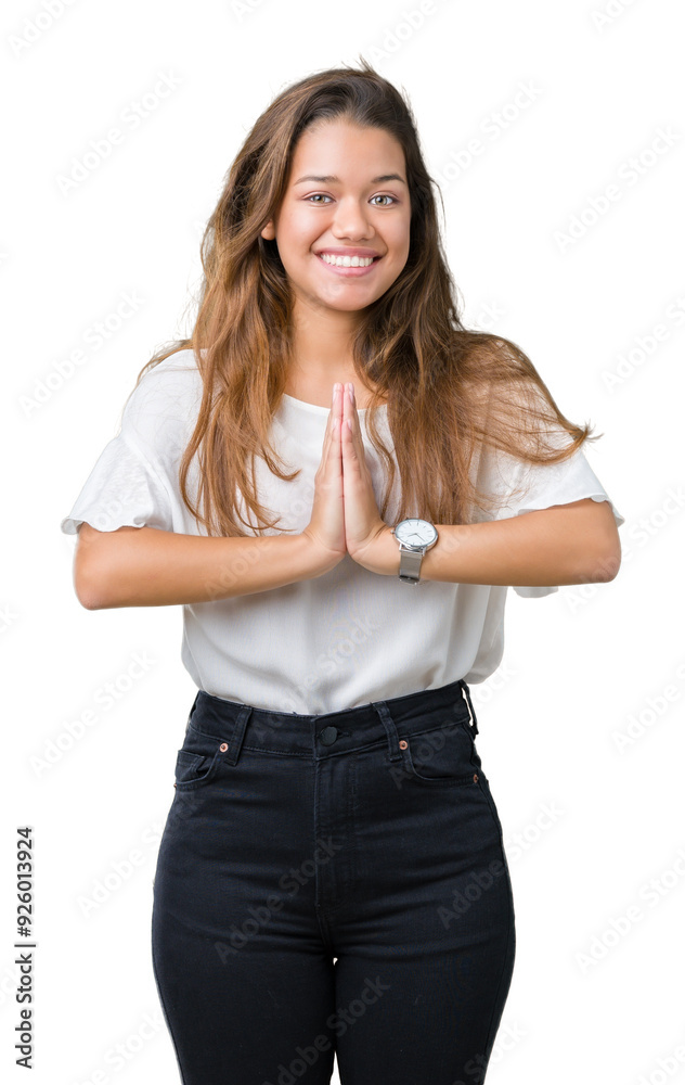 Canvas Prints Young beautiful brunette business woman over isolated background praying with hands together asking for forgiveness smiling confident.