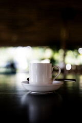 A ceramic cup of coffee cup and saucer on table