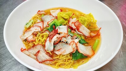 Thai food: Pork wonton soup in a white container