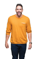 Fototapeta premium Young handsome man over isolated background sticking tongue out happy with funny expression. Emotion concept.