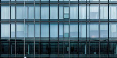 Fototapeta premium Close-up view of a modern glass and steel facade showcasing contemporary architectural design
