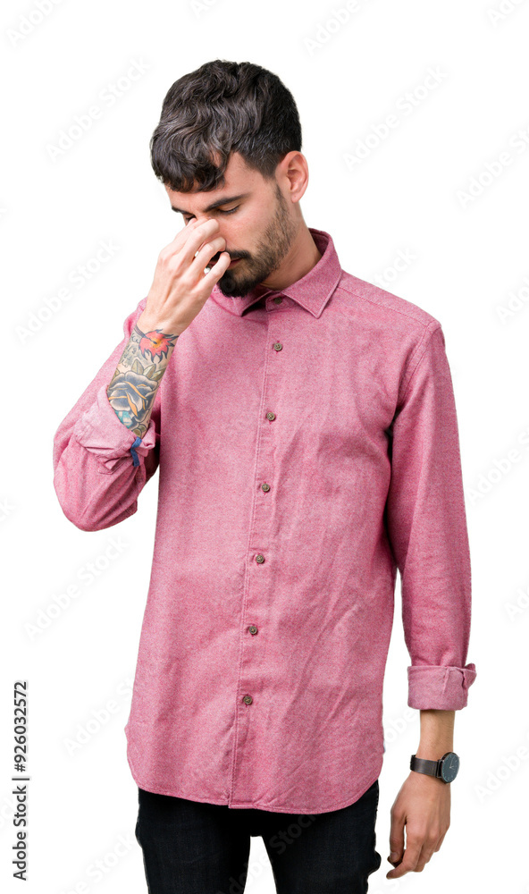 Sticker Young handsome man wearing pink shirt over isolated background tired rubbing nose and eyes feeling fatigue and headache. Stress and frustration concept.