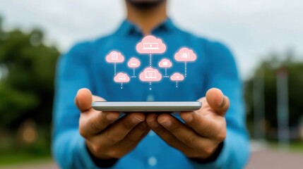 A person holds a smartphone displaying cloud icons, symbolizing cloud technology and digital connectivity in modern life.