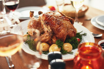 Food, roast chicken and thanksgiving on dining room table of home closeup for celebration event. Eating, feast and meal with cuisine dish in apartment for festive holiday or party in America