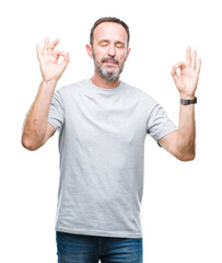 Middle age senior hoary man over isolated background relax and smiling with eyes closed doing meditation gesture with fingers. Yoga concept.