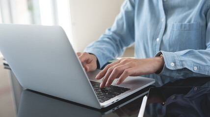 Businesswoman working on laptop computer at office. Business woman using portable computer, surfing the internet, searching the information, online working, e-learning concept